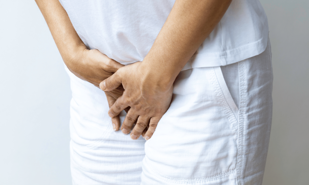 Person holding pelvis